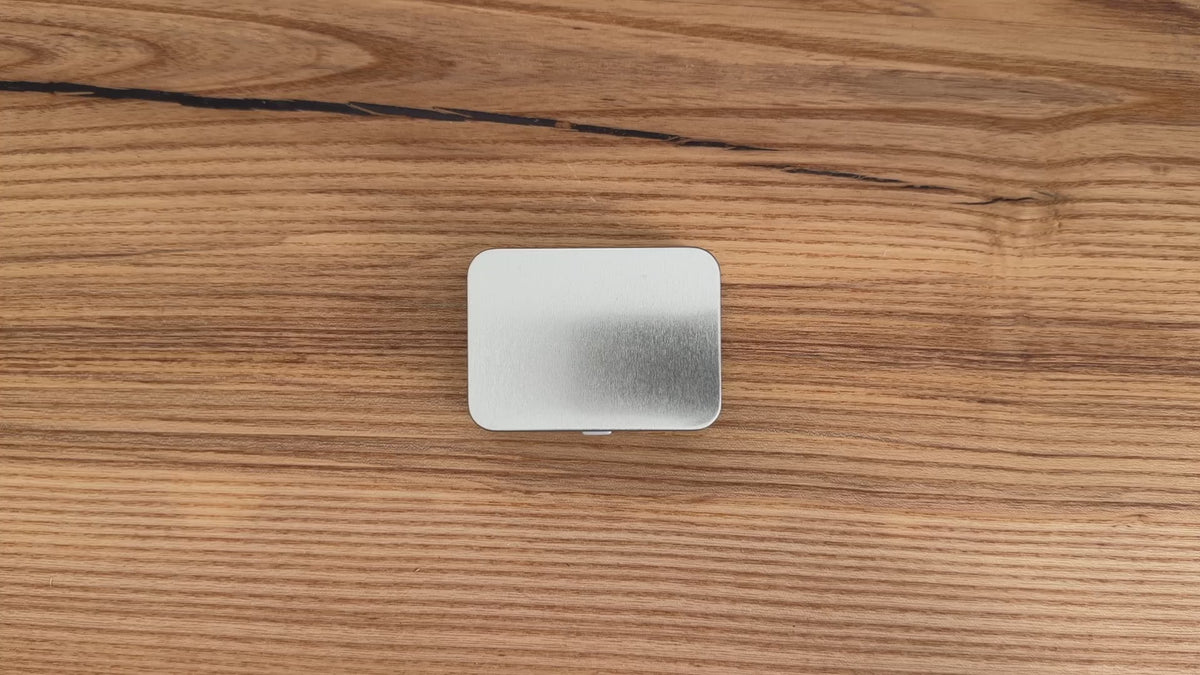 Video of 316 stainless steel Coin tactile object being removed from tin packaging and handled